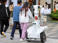 A 5G ''robot police'' patrols a business district in Zhoushan, China, on October 3, 2024. (