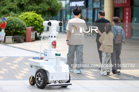 A 5G ''robot police'' patrols a business district in Zhoushan, China, on October 3, 2024. 