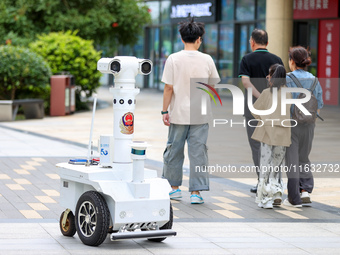 A 5G ''robot police'' patrols a business district in Zhoushan, China, on October 3, 2024. (