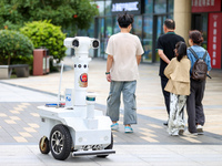 A 5G ''robot police'' patrols a business district in Zhoushan, China, on October 3, 2024. (