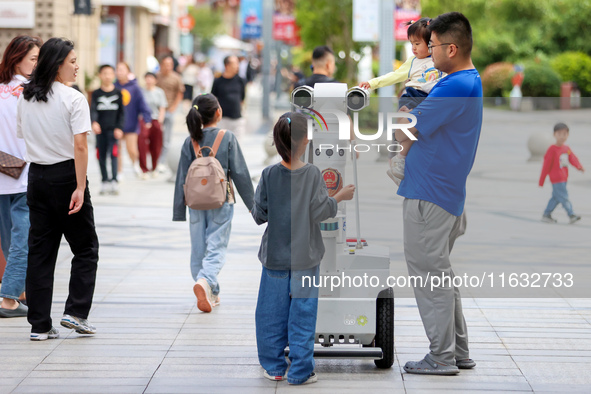 A 5G ''robot police'' patrols a business district in Zhoushan, China, on October 3, 2024. 