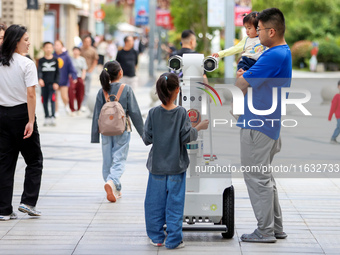 A 5G ''robot police'' patrols a business district in Zhoushan, China, on October 3, 2024. (