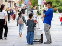 A 5G ''robot police'' patrols a business district in Zhoushan, China, on October 3, 2024. (