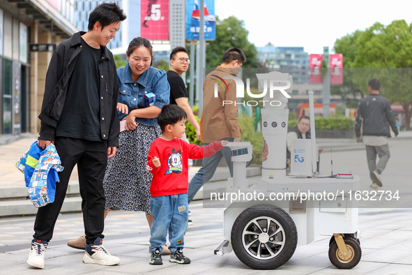 A 5G ''robot police'' patrols a business district in Zhoushan, China, on October 3, 2024. 