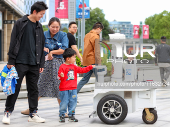 A 5G ''robot police'' patrols a business district in Zhoushan, China, on October 3, 2024. (