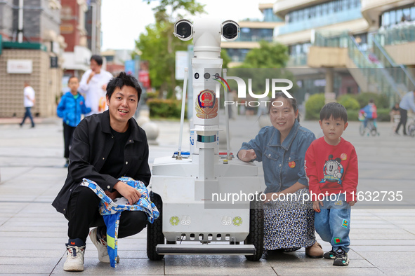 A 5G ''robot police'' patrols a business district in Zhoushan, China, on October 3, 2024. 