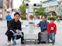 A 5G ''robot police'' patrols a business district in Zhoushan, China, on October 3, 2024. (