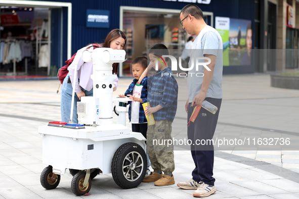 A 5G ''robot police'' patrols a business district in Zhoushan, China, on October 3, 2024. 