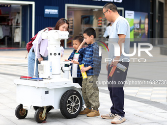 A 5G ''robot police'' patrols a business district in Zhoushan, China, on October 3, 2024. (