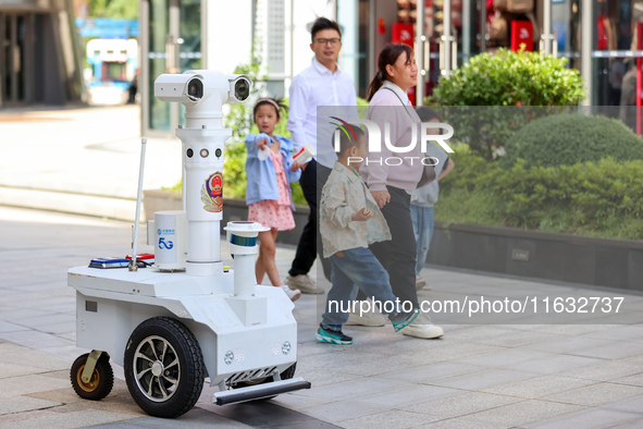 A 5G ''robot police'' patrols a business district in Zhoushan, China, on October 3, 2024. 