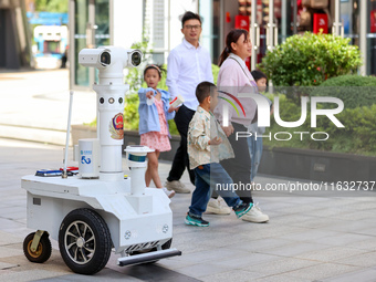 A 5G ''robot police'' patrols a business district in Zhoushan, China, on October 3, 2024. (