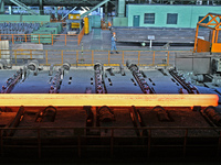 Workers perform a routine inspection at a hot rolling workshop of Lubao Steel Pipe Co., LTD in the Fushan district of Yantai, China, on Octo...