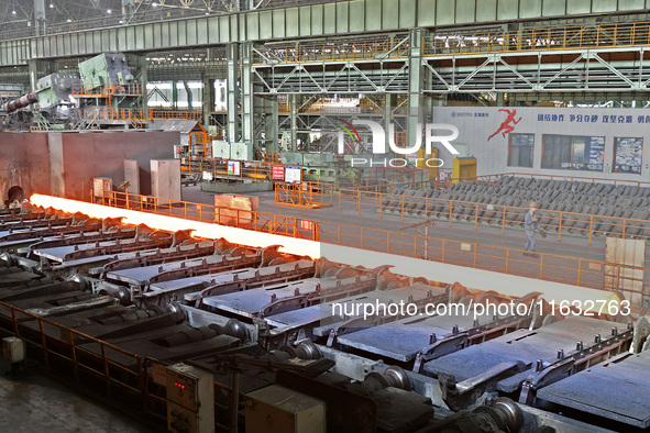 Workers perform a routine inspection at a hot rolling workshop of Lubao Steel Pipe Co., LTD in the Fushan district of Yantai, China, on Octo...