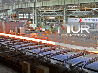 Workers perform a routine inspection at a hot rolling workshop of Lubao Steel Pipe Co., LTD in the Fushan district of Yantai, China, on Octo...