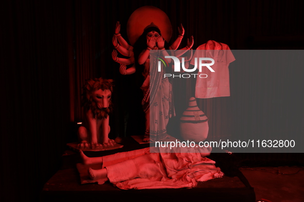 A Durga Puja pandal, a temporary platform, portrays idols of the Hindu goddess Durga to protest against the recent rape and murder of a post...