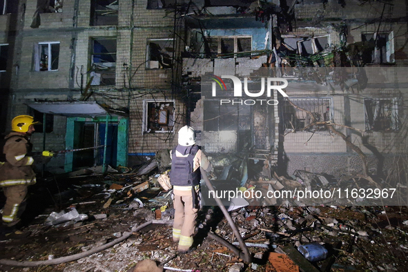 A firefighter puts out a fire in a residential building damaged by a Russian guided missile strike in Kharkiv, Ukraine, on September 3, 2024...