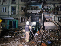 A firefighter puts out a fire in a residential building damaged by a Russian guided missile strike in Kharkiv, Ukraine, on September 3, 2024...