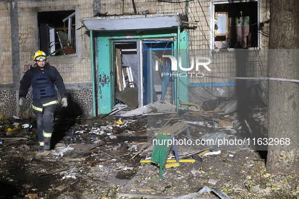 A firefighter stands outside the residential building damaged by a Russian guided missile strike in Kharkiv, Ukraine, on September 3, 2024. 