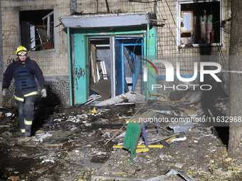 A firefighter stands outside the residential building damaged by a Russian guided missile strike in Kharkiv, Ukraine, on September 3, 2024....