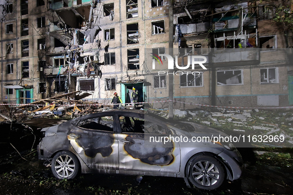 A burned-down car is seen outside the residential building damaged by a Russian guided missile strike in Kharkiv, Ukraine, on September 3, 2...