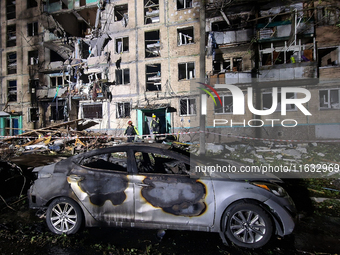 A burned-down car is seen outside the residential building damaged by a Russian guided missile strike in Kharkiv, Ukraine, on September 3, 2...