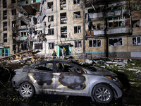 A burned-down car is seen outside the residential building damaged by a Russian guided missile strike in Kharkiv, Ukraine, on September 3, 2...