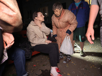 Local residents are seen outside the apartment building damaged by a Russian guided missile strike in Kharkiv, Ukraine, on September 3, 2024...