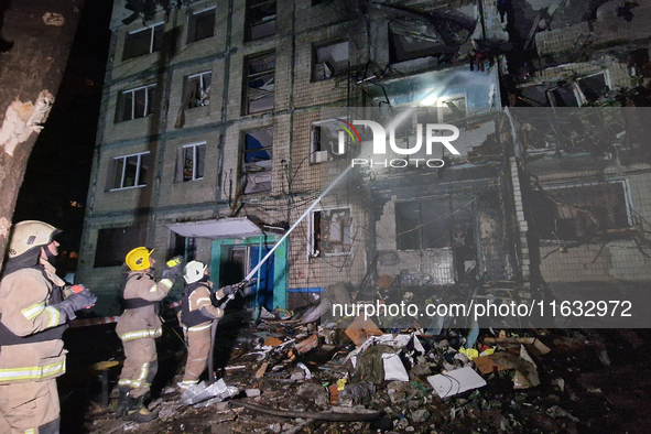 Firefighters put out a fire in a residential building damaged by a Russian guided missile strike in Kharkiv, Ukraine, on September 3, 2024. 