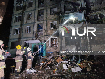 Firefighters put out a fire in a residential building damaged by a Russian guided missile strike in Kharkiv, Ukraine, on September 3, 2024....