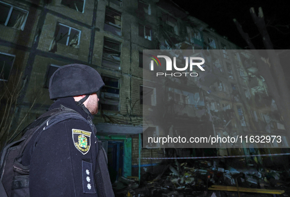 A policeman is seen outside a residential building damaged by a Russian guided missile strike in Kharkiv, Ukraine, on September 3, 2024. 