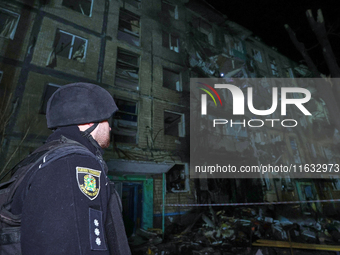 A policeman is seen outside a residential building damaged by a Russian guided missile strike in Kharkiv, Ukraine, on September 3, 2024. (