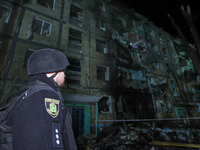 A policeman is seen outside a residential building damaged by a Russian guided missile strike in Kharkiv, Ukraine, on September 3, 2024. (