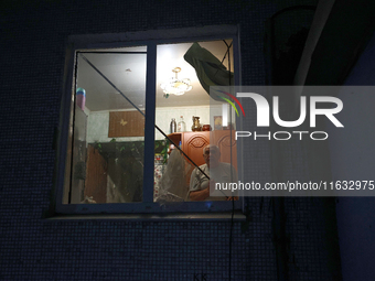 A man is seen through the window of the residential building damaged by a Russian guided missile strike in Kharkiv, Ukraine, on September 3,...