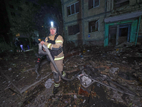 A rescuer is seen outside the residential building damaged by a Russian guided missile strike in Kharkiv, Ukraine, on September 3, 2024. (