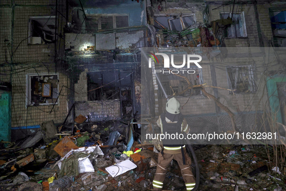 A firefighter puts out a fire in a residential building damaged by a Russian guided missile strike in Kharkiv, Ukraine, on September 3, 2024...