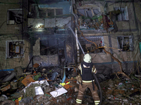 A firefighter puts out a fire in a residential building damaged by a Russian guided missile strike in Kharkiv, Ukraine, on September 3, 2024...