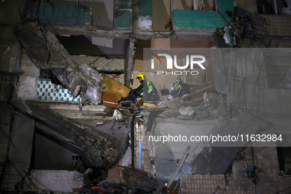 Rescuers are seen in a residential building damaged by a Russian guided missile strike in Kharkiv, Ukraine, on September 3, 2024. NO USE RUS...