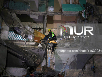 Rescuers are seen in a residential building damaged by a Russian guided missile strike in Kharkiv, Ukraine, on September 3, 2024. NO USE RUS...