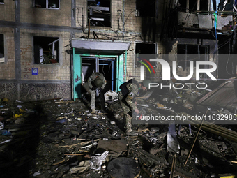 Servicemen are seen outside a residential building damaged by a Russian guided missile strike in Kharkiv, Ukraine, on September 3, 2024. (