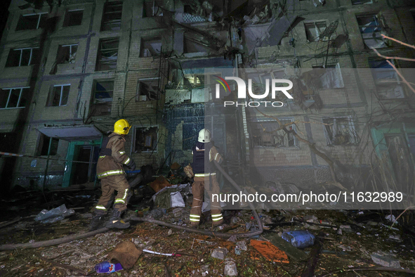 Firefighters put out a fire in a residential building damaged by a Russian guided missile strike in Kharkiv, Ukraine, on September 3, 2024. 