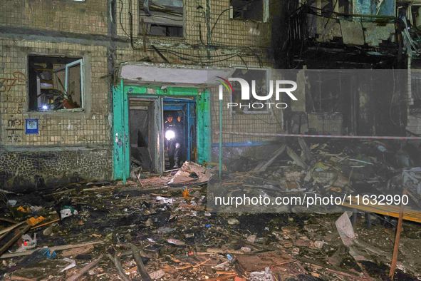 A rescuer walks out of the residential building damaged by a Russian guided missile strike in Kharkiv, Ukraine, on September 3, 2024. 