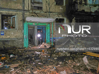 A rescuer walks out of the residential building damaged by a Russian guided missile strike in Kharkiv, Ukraine, on September 3, 2024. (