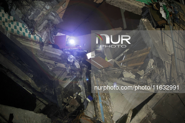 Rescuers are seen in a residential building damaged by a Russian guided missile strike in Kharkiv, Ukraine, on September 3, 2024. NO USE RUS...