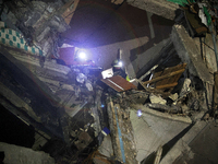 Rescuers are seen in a residential building damaged by a Russian guided missile strike in Kharkiv, Ukraine, on September 3, 2024. NO USE RUS...