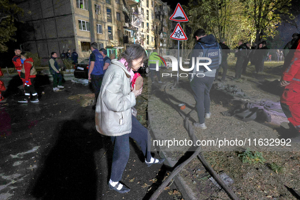 People are seen outside a residential building damaged by a Russian guided missile strike in Kharkiv, Ukraine, on September 3, 2024. NO USE...