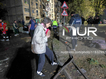 People are seen outside a residential building damaged by a Russian guided missile strike in Kharkiv, Ukraine, on September 3, 2024. NO USE...