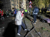 People are seen outside a residential building damaged by a Russian guided missile strike in Kharkiv, Ukraine, on September 3, 2024. NO USE...