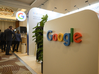 People stand by a Google stand during the Warsaw Security Forum 2024 in Warsaw, Poland on October 2, 2024. WSF2024, entitled 'Ensuring Secur...