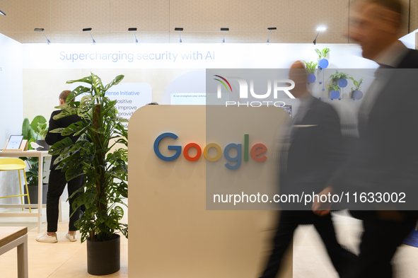 People walk past a Google stand during the Warsaw Security Forum 2024 in Warsaw, Poland on October 2, 2024. WSF2024, entitled 'Ensuring Secu...