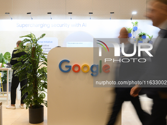 People walk past a Google stand during the Warsaw Security Forum 2024 in Warsaw, Poland on October 2, 2024. WSF2024, entitled 'Ensuring Secu...